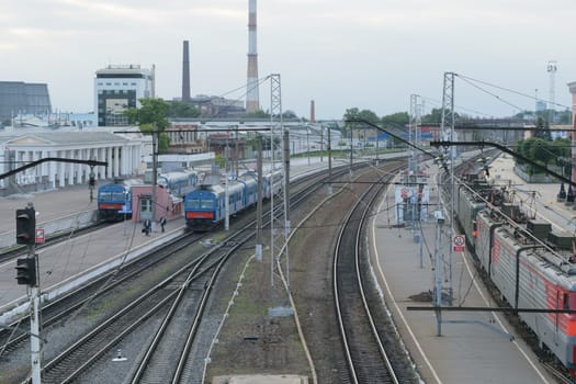 Railway station. Trains, platform, wagons, people. The view from the highest point.