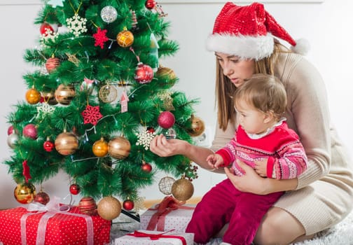 Christmas Happy Family mother and her little daughter open Holidays Gift.