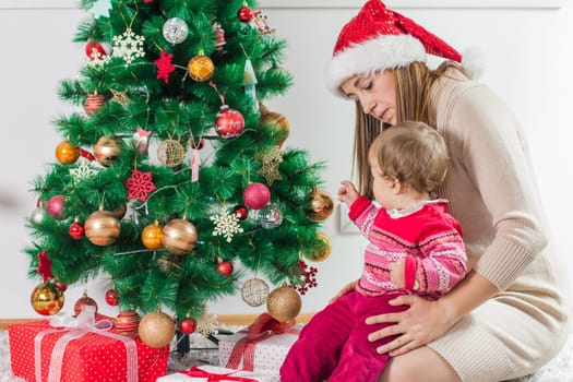 Christmas Happy Family mother and her little daughter open Holidays Gift.