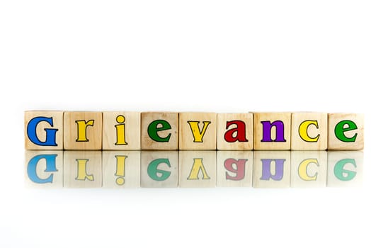 grievance colorful wooden word block on the white background