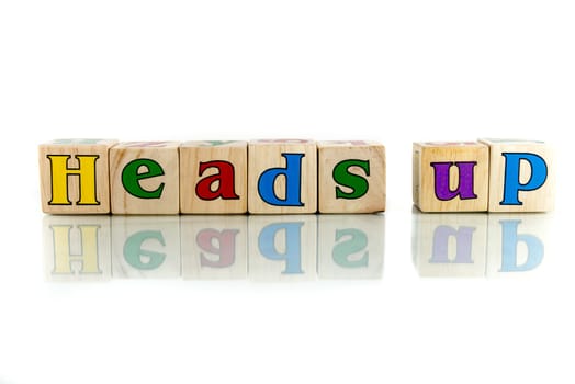 heads up colorful wooden word block on the white background