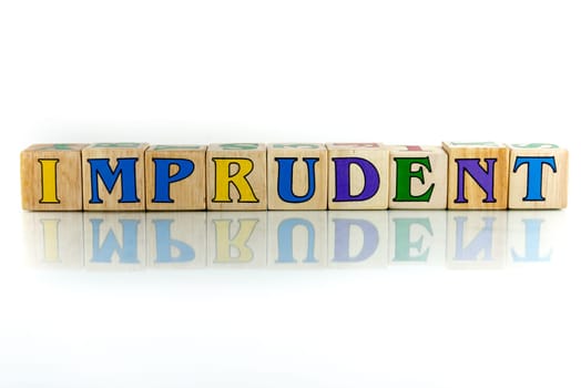imprudent colorful wooden word block on the white background