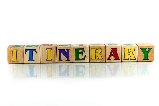 itinerary colorful wooden word block on the white background