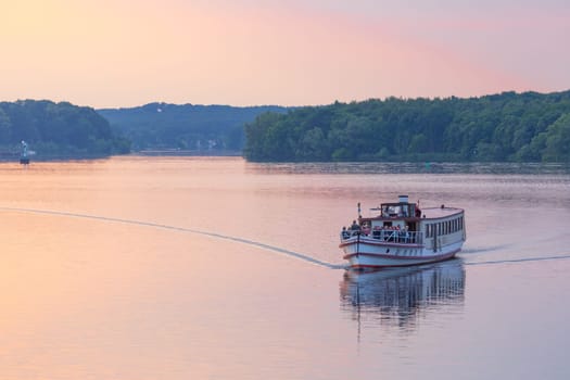 Tourist ship in the evening red on the Hafel in Potsdam