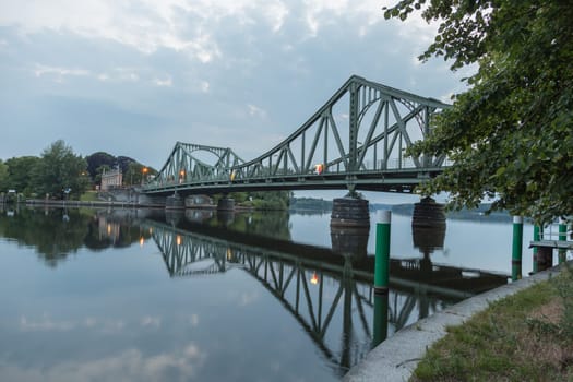 Glienicker Bridge is reflected in the Havel in Potsdam