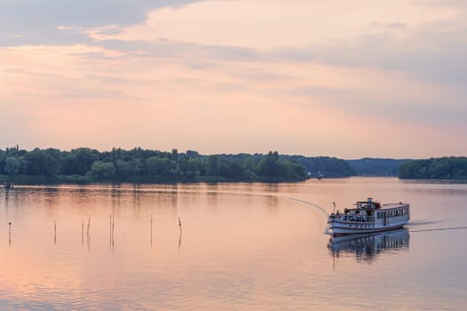 Tourist ship in the evening red on the Hafel in Potsdam