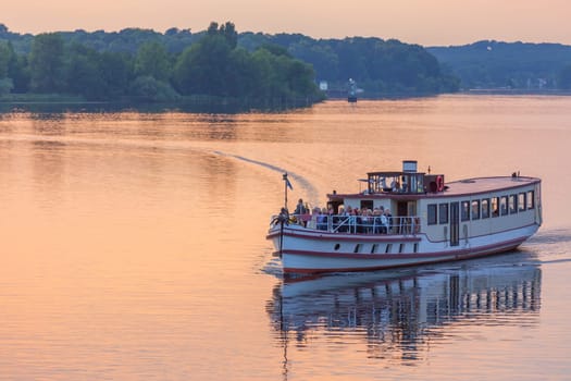 Tourist ship in the evening red on the Hafel in Potsdam