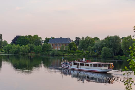 Tourist boat in front of a Potsdam villa on the Havel