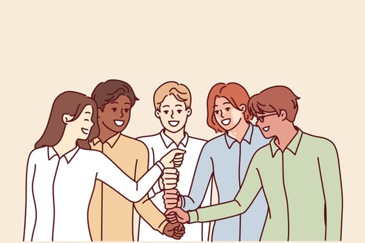 Happy diverse business team of employees celebrating success by touching with fists in center and enjoying working together. Positive people cooperate together to achieve best results and meet KPIs