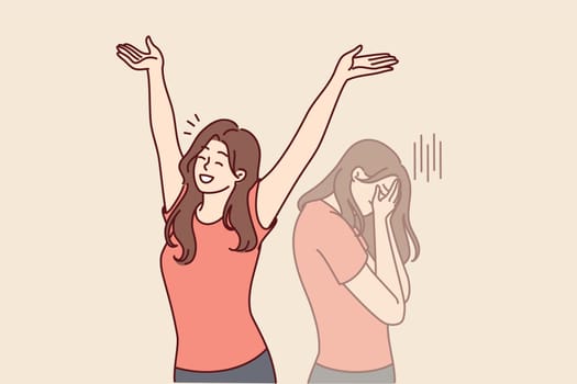 Positive woman raises hands up and rejoices having got rid of bad emotions and depression spoiling mood. Crying doppelganger behind girl for concept of mood swings or split personality
