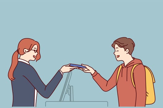 Woman working as secretary or at hotel at reception serves man by holding out magnetic key or invoice for paying for room. Seller girl serves buyer by giving him goods and helps to make choice
