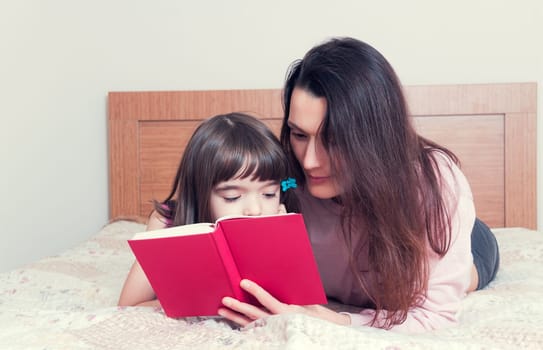 Mom with the daughter reading together