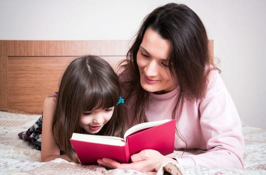 Mom with the daughter reading together