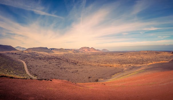 View on the desolate volcanic and moonlike landscape of Timanfaya National Park on Lanzarote, one of the Canary Islands of Spain and a famous travel destination for holidays