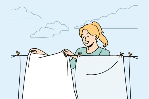 Smiling woman hanging fresh clothes on wire to dry outdoors. Happy housewife drying clothing on washing line. Household and chores. Vector illustration.