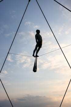 Cracow, Poland - May 2, 2022: Balancing sculptures between sky and water by Jerzy Kedziora over the Kornatka footbridge over the Vistula River in Krakow