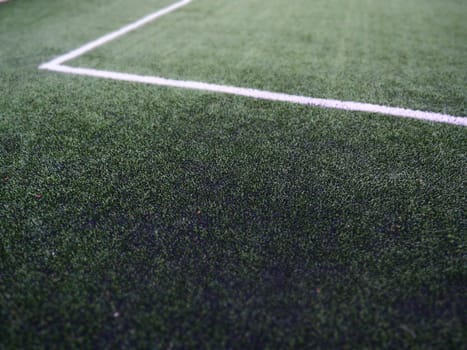 The marking of the football field on the green grass. White lines no more than 12 cm or 5 inches wide. Football field area