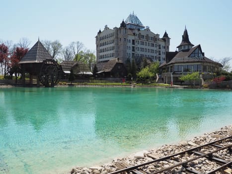 Stanisici, Bijelina, Republika Srpska, Bosnia and Herzegovina April 25 2021 Ethno village, tourism and attractions. Stone and wooden buildings of the hotel. People visit restaurant, traditional houses
