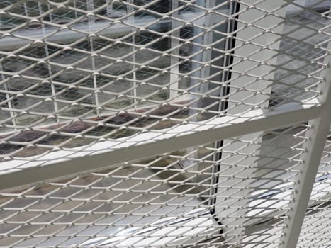 New white frames and windows. Metal fence for the safety of schoolchildren. New modern school. View from the window to the opposite wall and windows. Security systems. Internal office interior