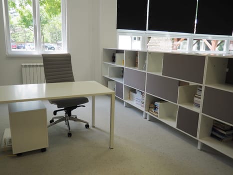 Sremska Mitrovica, Serbia, May 15, 2021. Interior of the school library. Modern school equipment. Equipment of the school and the learning process. Bookshelves. Blackout curtains and blinds on windows.