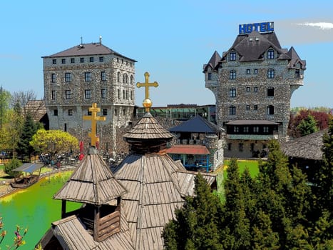 Stanisici, Bijelina, Republika Srpska, Bosnia and Herzegovina April 25 2021 Ethno village, tourism and attractions. Stone and wooden buildings of the hotel. People visit restaurant, traditional houses