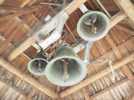 Old grunge bell. Bells in the bell tower. Large metal bells under a wooden roof. Stanisici, Bijelina, Republika Srpska, Bosnia and Herzegovina. Religious buildings for ceremonies.