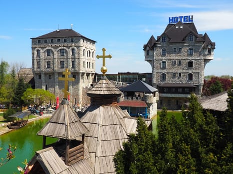 Stanisici, Bijelina, Republika Srpska, Bosnia and Herzegovina April 25 2021 Ethno village, tourism and attractions. Stone and wooden buildings of the hotel. People visit restaurant, traditional houses