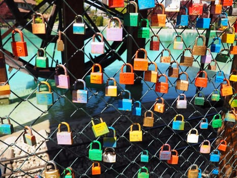 Stanisici, Bijelina, Bosnia and Herzegovina. April 25, 2021 Locks of love on a metal mesh. Many colorful beautiful castles were left by young wives and lovers. Locks hang from the fence.