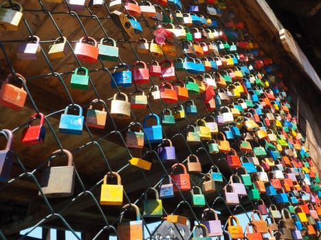 Stanisici, Bijelina, Bosnia and Herzegovina. April 25, 2021 Locks of love on a metal mesh. Many colorful beautiful castles were left by young wives and lovers. Locks hang from the fence.