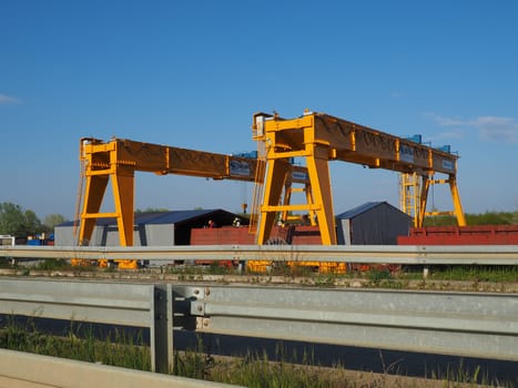 Sremska Raca, 25 April 2021. Construction of a bridge on the Sava river, crane operation, beams and concrete structures. Infrastructure project auto route Belgrade - Sarajevo. Road construction works.