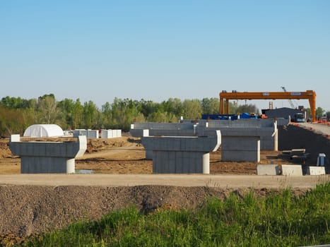 Sremska Raca, 25 April 2021. Construction of a bridge on the Sava river, crane operation, beams and concrete structures. Infrastructure project auto route Belgrade - Sarajevo. Road construction works.