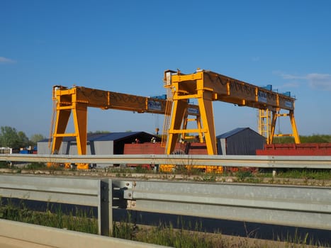 Sremska Raca, 25 April 2021. Construction of a bridge on the Sava river, crane operation, beams and concrete structures. Infrastructure project auto route Belgrade - Sarajevo. Road construction works.