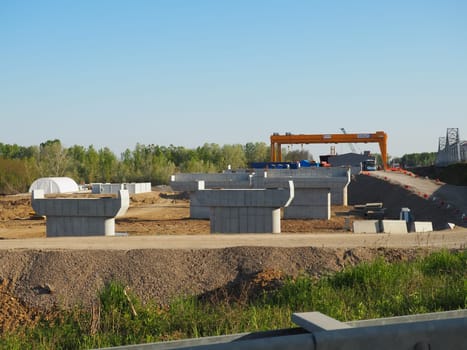 Sremska Raca, 25 April 2021. Construction of a bridge on the Sava river, crane operation, beams and concrete structures. Infrastructure project auto route Belgrade - Sarajevo. Road construction works.