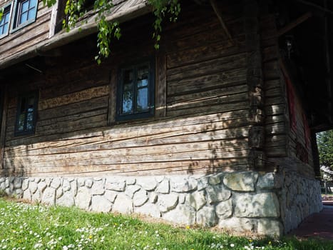 Stanisici, Bijelina, Bosnia and Herzegovina, 25 April 2021. Log village farmhouse. 19th century Bosnian mountain traditional dwelling. Restored ethno building, implements of agricultural labor