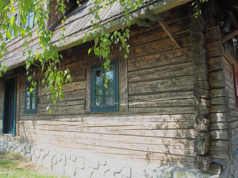 Log village farmhouse. 19th century Bosnian mountain traditional dwelling. Restored ethno building, implements of agricultural labor