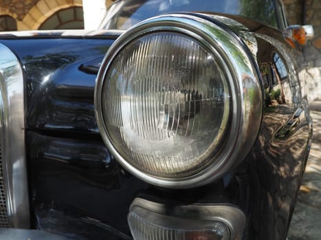 Vintage old headlight of a Mercedes Benz car, pontoon model. Retro car in good condition. Product of the German car industry.