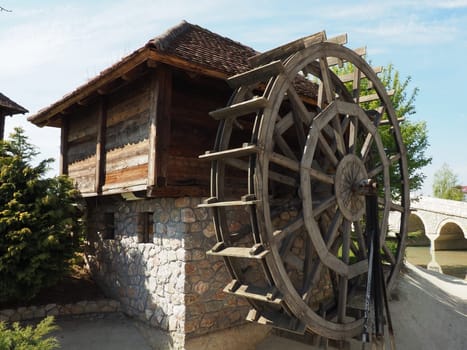 Wooden water mill. A hydraulic structure using hydropower from a water wheel. Useful work by means of a gear train.