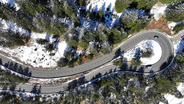 Aerial shot with drone of tight curve with cars at Gaichtpass in Tyrol
