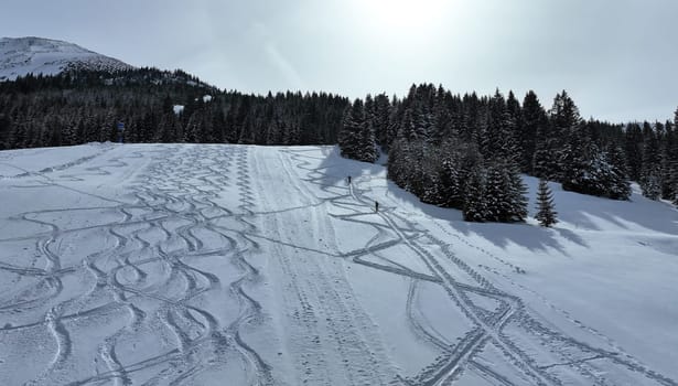 Aerial photo with drone of ski resort in winter with two ski tourers