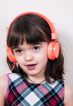Little girl using the earphones
