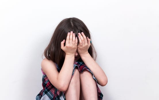 Small girl sitting in depression