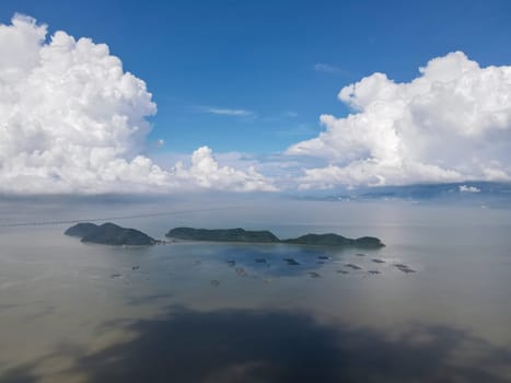 Aerial view blue sunny day at Pulau Aman and Pulau Gedong. Kelong or fish farm at sea