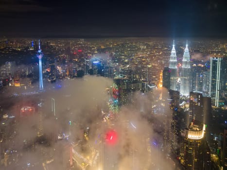 Kuala Lumpur cloudy night view in night. KLCC and KL Tower illuminated