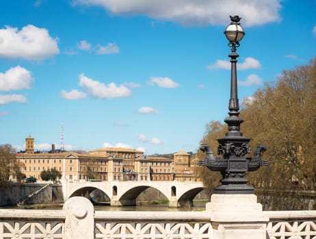Rome. Ponte Mazzini, over Tiber river. The bottom of the lights on the bridge show beautiful ironwork.