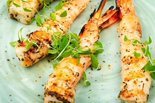 Tiger shrimp barbecue with herbs grilled on wooden sticks.