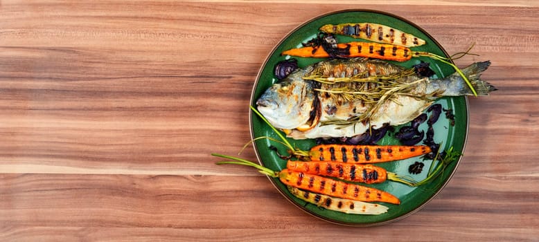 Baked dorado fish or sea bream with grilled vegetables on concrete background. Flat Lay