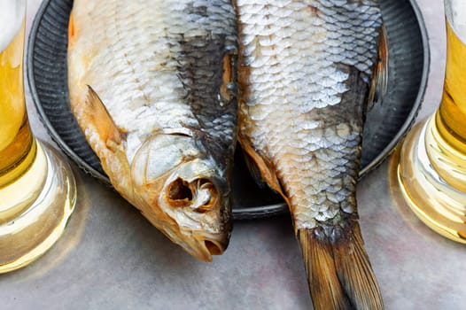 Two dried salted fish on the wooden table.Stockfish