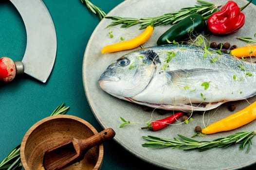 Uncooked dorado fish with ingredients for cooking. Top view