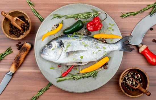 Uncooked dorado fish with ingredients for cooking. Top view