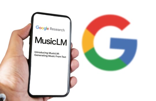 San Francisco US, Feb 2023: A hand holding a phone with the Google MusicLM website on the screen. White background with blurred Google logo. Bard is Google artificial intelligence chatbot
